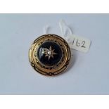 An antique onyx circular memorial brooch/hair locket with bulls eye pearl dated 23rd March 1867 -