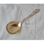 A decorative caddy spoon in sterling silver gilt bowl