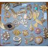 A pad of attractive costume brooches