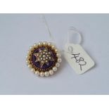 An amethyst and pearl dome brooch mounted in gold 9g inc