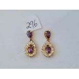 A pair of stone set pear drop earrings in 9ct settings 6.7g