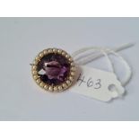 A circular amethyst & pearl brooch set in gold