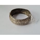 A metal engraved wide bangle