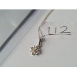 A white gold diamond pendant (0.25ct) on chain both in 9ct with certificate