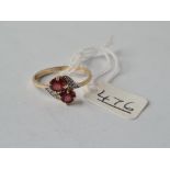 A ring with 2 central red stones in 9ct - size S - 1.7gms