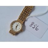 A ROTARY LADIES QUARTZ WATCH WITH STONE SURROUND IN 9CT WITH 9CT FLEXIBLE STRAP - 25gms