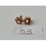 A pair of opal & garnet stud earrings in 9ct - hallmarked on stems