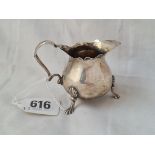 A small Victorian cream jug on 3 claw feet 2 inches high Birmingham 1896 by M Bros 43 grms