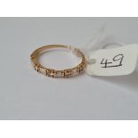 A 9 STONE BAGUETTE DIAMOND HALF ETERNITY RING IN HIGH CARAT GOLD - size R - 1.8gms