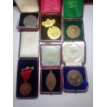 Six school medals in boxes