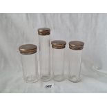 A set of four hat pin jars with glass bodies London 1924