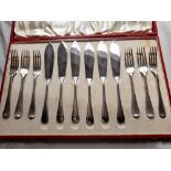 A boxed set of 6 fish knives and forks