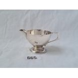 A small cream jug on spreading rim foot 3 1/2 inches over handle B'ham 1912 44 gms