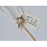An attractive gold stick pin mounted with calibrated emerald & diamond swirl & a single pearl