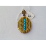 A metal & turquoise oval locket