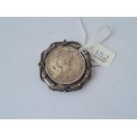 A silver 1892 one rupee coin in mount