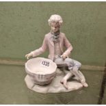 A Lladro figure of man seated by bowl - 7" high