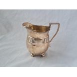 A Georgian style milk jug of 4 ball feet London 1897 200 gms