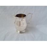 A pitcher style cream jug with leaf capped handle 3 1/2 inches high B'ham 1966 111 gms