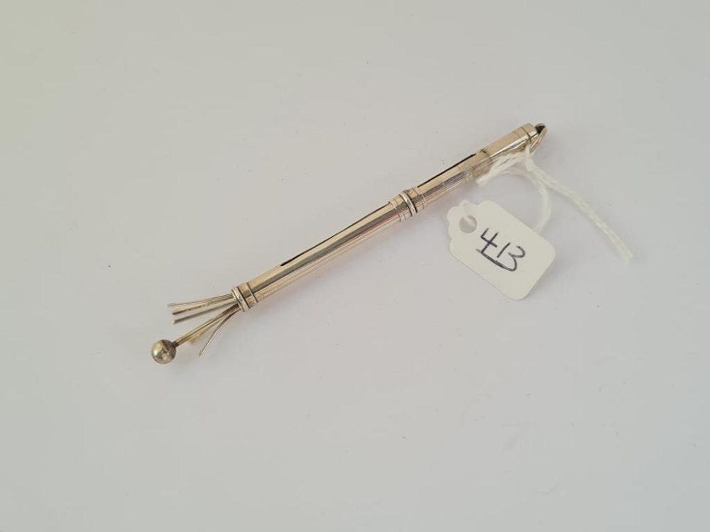 A silver swizzle stick