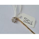 A solitaire diamond stick pin in high carat gold