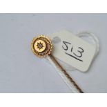A stick pin with a single diamond in 15ct gold