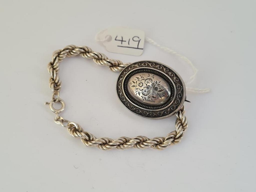 A silver rope twist bracelet & Victorian brooch