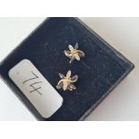 A pair of sapphire & diamond earrings in 9ct - full hallmarks on stem