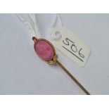 A vintage stick pin with pink composition terminal of a ladies bust