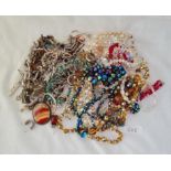 A bag of assorted costume jewellery