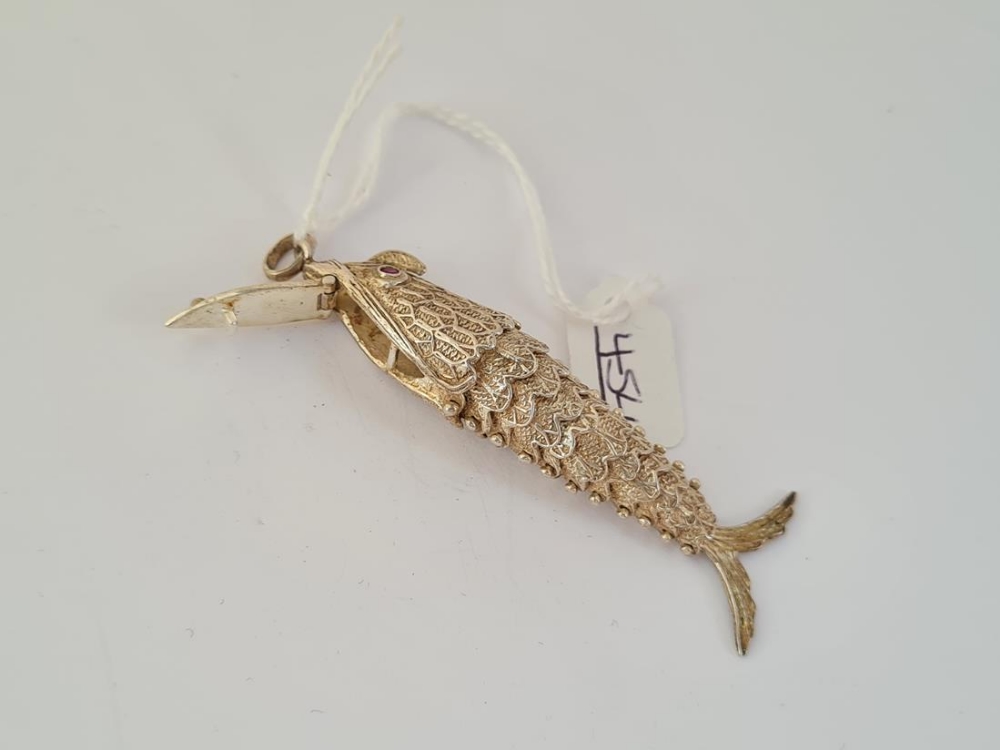 A silver articulated fish pendant