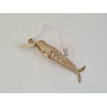A silver articulated fish pendant