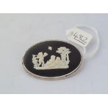 An oval black Wedgwood brooch