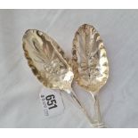 A pair of early George III bottom marked berry spoons chased with fruit and foliage one London 1758