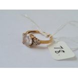 A dress ring with large central white stone & smaller in 9ct - hallmarked - size N - 3.1gms