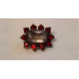 A vintage red paste brooch with crystal centre set in gold