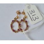 A pair of ruby set oval ear drops in 9ct