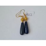 A pair of large lapis lazuli ear pendants mounted in fancy yellow metal mounts