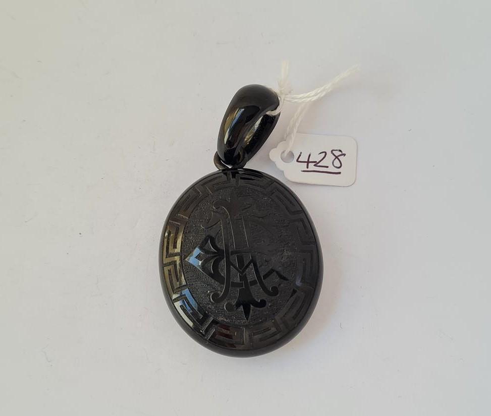 A carved jet locket