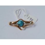 An art nouveau brooch set with a turquoise in 9ct
