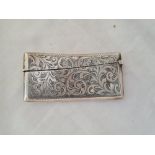 A card case of curved outline engraved with scrolls B'ham 1908