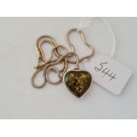 A silver mounted heart pendant necklace on silver chain