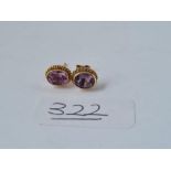A pair of amethyst circular earrings in 9ct