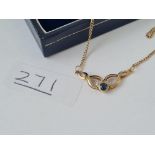 A sapphire & diamond pendant in 9ct yellow gold on a chain marked DIA