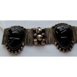 A Mexican silver tribal mask carved stone bracelet