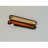 An cased amber cigarette holder with 9ct mount