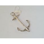 A silver brooch in the form of an anchor