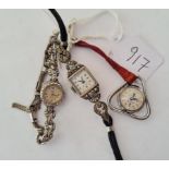A marcasite wrist watch by UNO together with a siller & marcasite watch & unusual triangular lapel
