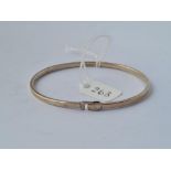 A silver bangle - 10.5gms