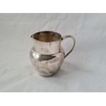 A cream jug with loop handle B'ham 1910 3 inches high 68 gms
